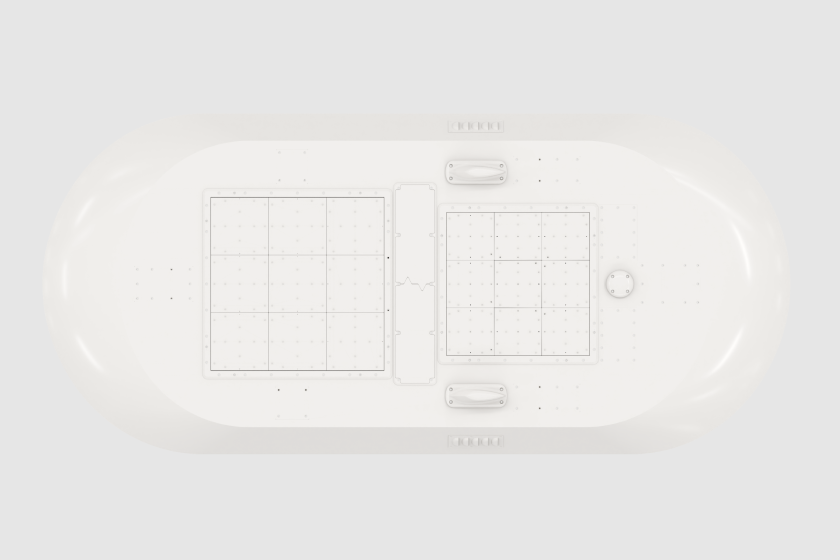 Top-down view of a white, elongated rectangular object with two square panels and handles in the center